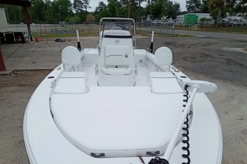 Slide: The Image of 2021 Sportsman Masters 207 Bay Boat with white seating and spacious deck. - 5