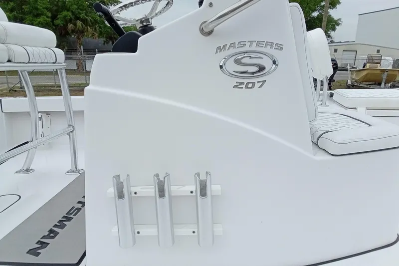 Slide: The Image of 2021 Sportsman Masters 207 Bay Boat interior with seating and rod holders. - 9
