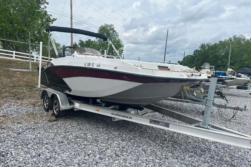 The Image of 2024 Starcraft SVX 191 OB boat on trailer, parked on gravel lot. - 0