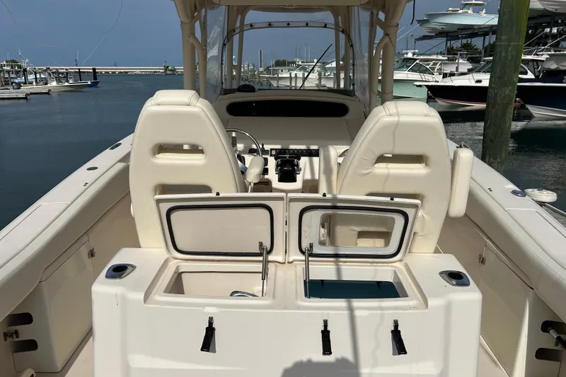 Slide: The Image of 2016 Grady-White Canyon 306 boat interior with open storage compartments at marina. - 11