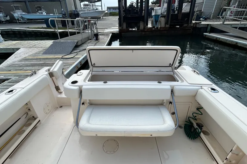 Slide: The Image of 2016 Grady-White Canyon 306 boat with open storage compartment at dockside. - 15