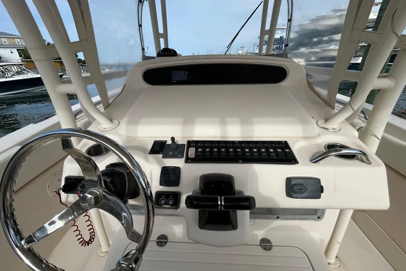 Slide: The Image of 2016 Grady-White Canyon 306 boat helm with steering wheel and control panel. - 17