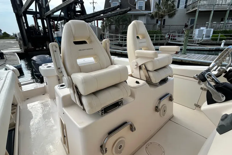Slide: The Image of 2016 Grady-White Canyon 306 boat interior with dual captain's chairs at the dock. - 18