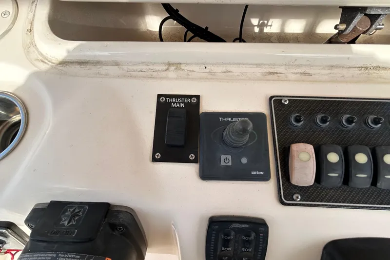 Slide: The Image of Control panel of a 2016 Grady-White Canyon 306 boat with thruster controls. - 20