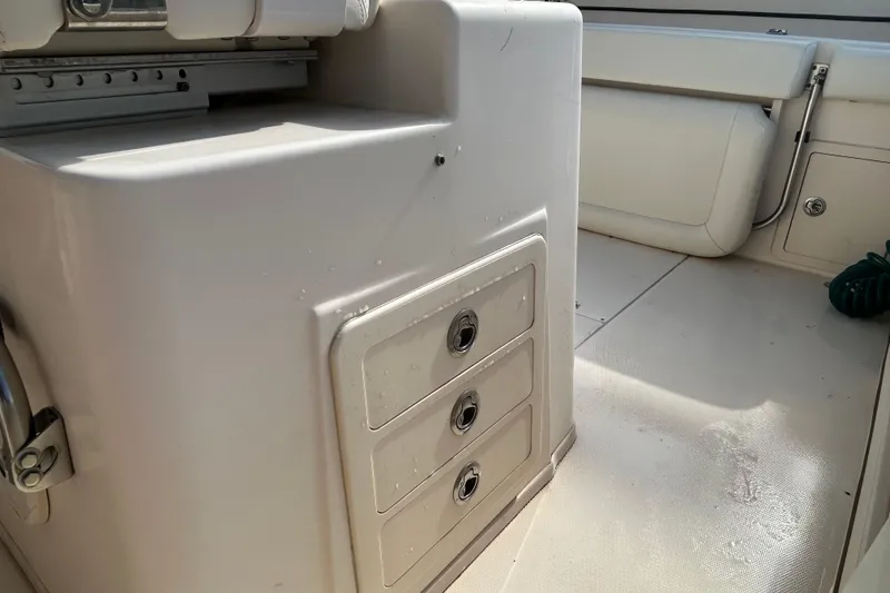 Slide: The Image of 2016 Grady-White Canyon 306 boat interior with storage compartments and seating. - 24