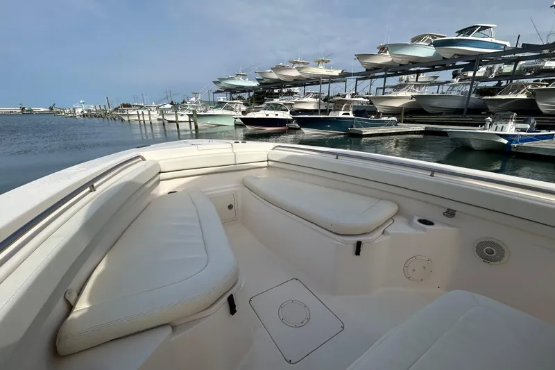 Slide: The Image of 2016 Grady-White Canyon 306 boat interior at marina with stacked boats in background. - 25