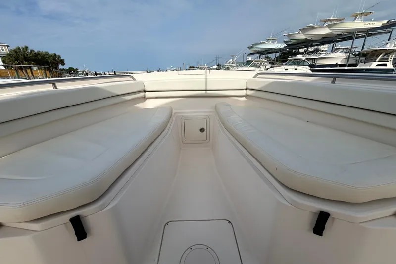 Slide: The Image of 2016 Grady-White Canyon 306 boat interior with white cushioned seating. - 27