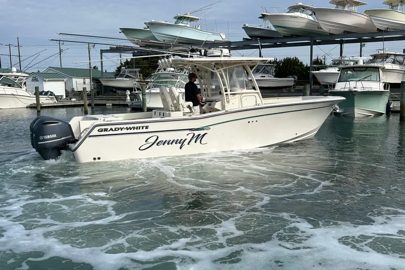 Slide: The Image of 2016 Grady-White Canyon 306 boat named "Jenny M" in marina with Yamaha engine. - 4