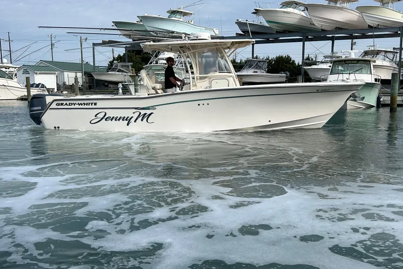 Slide: The Image of 2016 Grady-White Canyon 306 boat named "JennyM" on water near marina. - 5