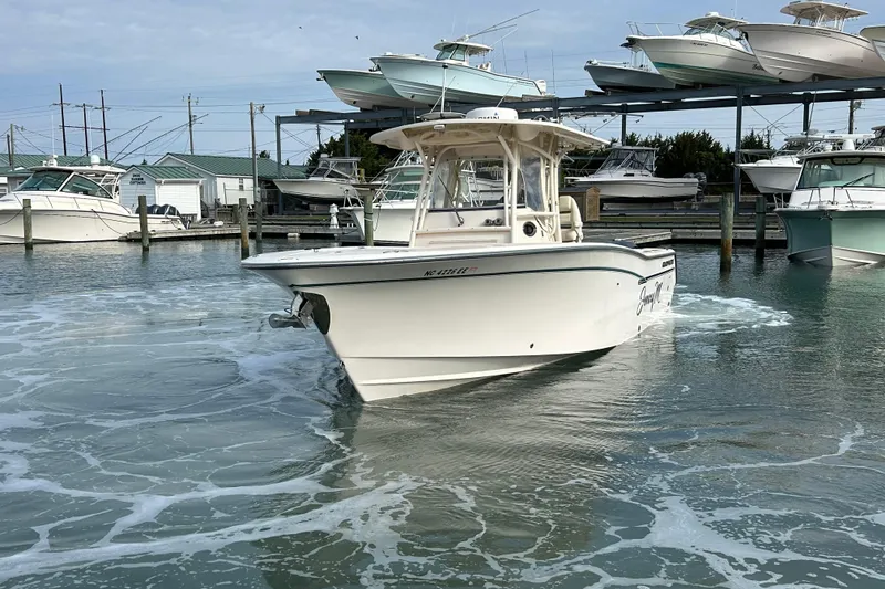 Slide: The Image of 2016 Grady-White Canyon 306 boat docked at a marina with other vessels. - 8