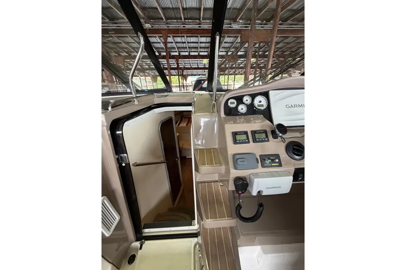 Slide: The Image of 2016 Regal 35 Sport Coupe helm with Garmin navigation and cabin entrance. - 11