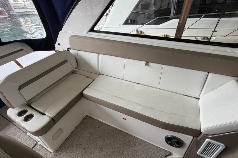 Slide: The Image of Interior seating of a 2016 Regal 35 Sport Coupe with beige and white upholstery. - 13