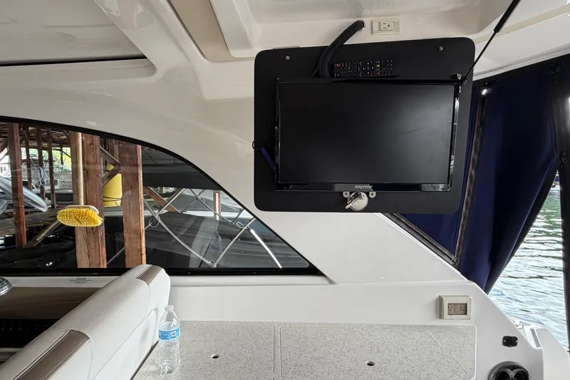 Slide: The Image of Interior of a 2016 Regal 35 Sport Coupe with mounted TV and seating area. - 14
