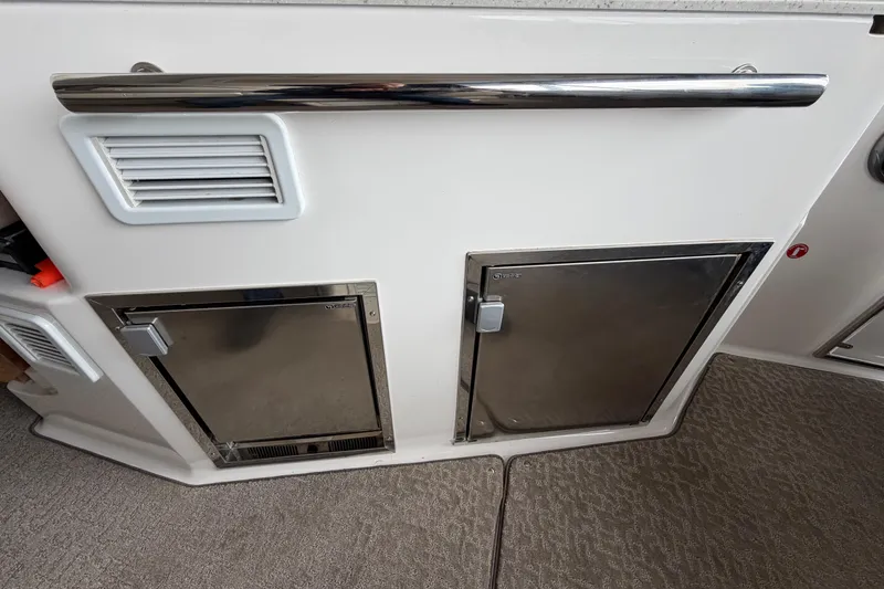 Slide: The Image of 2016 Regal 35 Sport Coupe interior with stainless steel storage compartments and vent. - 16
