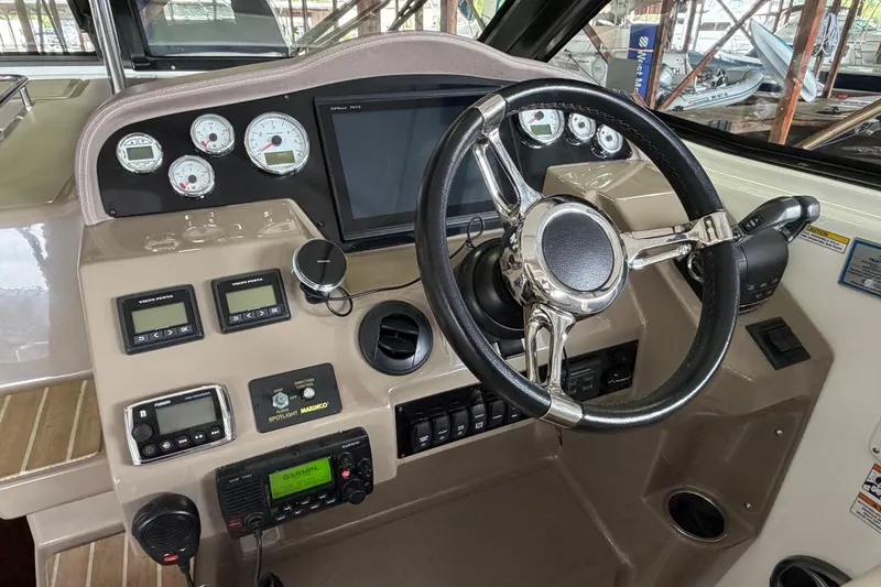 Slide: The Image of Cockpit of 2016 Regal 35 Sport Coupe with steering wheel and control panel. - 17