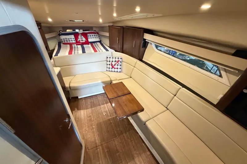 Slide: The Image of Interior of 2016 Regal 35 Sport Coupe with cozy seating and nautical-themed bedding. - 21