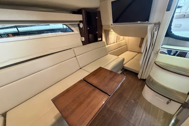 Slide: The Image of Interior of 2016 Regal 35 Sport Coupe with beige seating and wooden table. - 23