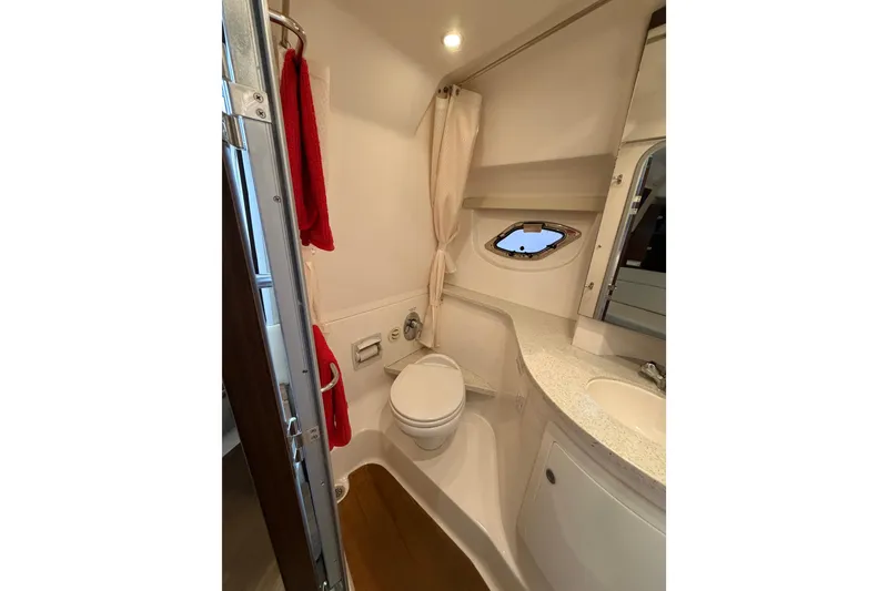 Slide: The Image of Bathroom interior of 2016 Regal 35 Sport Coupe with modern fixtures and porthole window. - 25