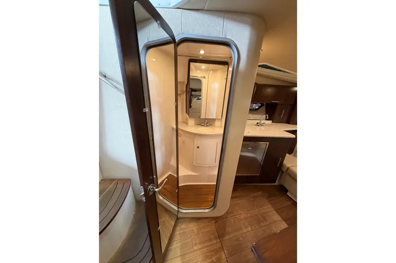 Slide: The Image of Interior of 2016 Regal 35 Sport Coupe yacht, featuring a modern bathroom and kitchenette. - 26