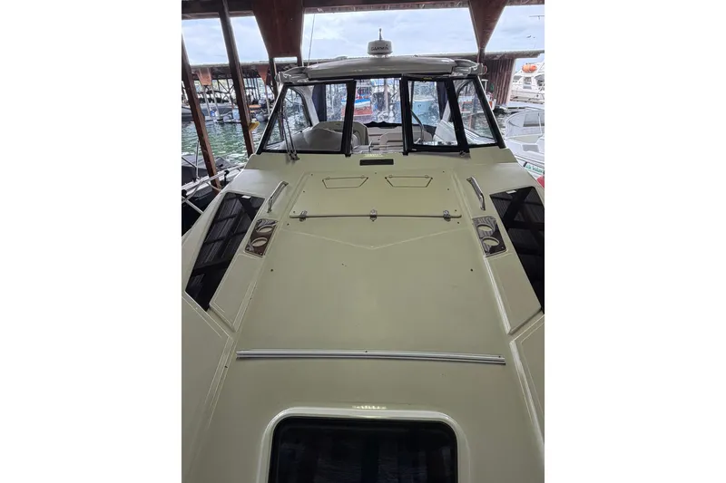 Slide: The Image of 2016 Regal 35 Sport Coupe boat docked, showcasing sleek design and spacious deck. - 3