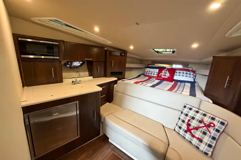 Slide: The Image of Interior of 2016 Regal 35 Sport Coupe with kitchenette and cozy sleeping area. - 31