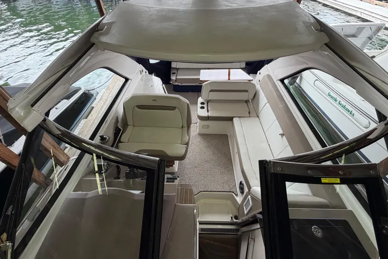 Slide: The Image of Interior view of a 2016 Regal 35 Sport Coupe boat, featuring seating and helm area. - 5