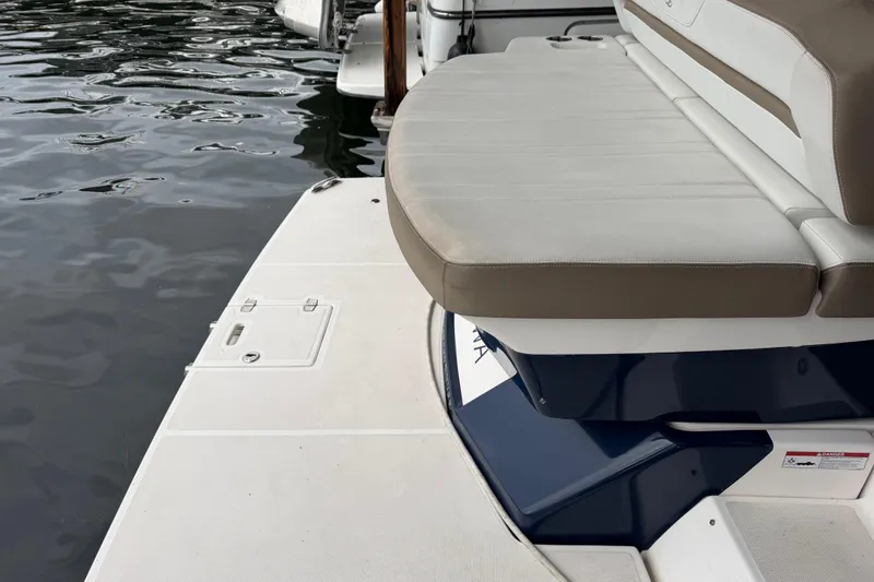 Slide: The Image of Rear seating and swim platform of a 2016 Regal 35 Sport Coupe boat by the water. - 6