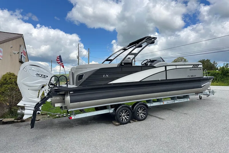 Slide: The Image of 2024 Bennington LX Sport Line pontoon boat on trailer, featuring Yamaha XTO outboard motor. - 11