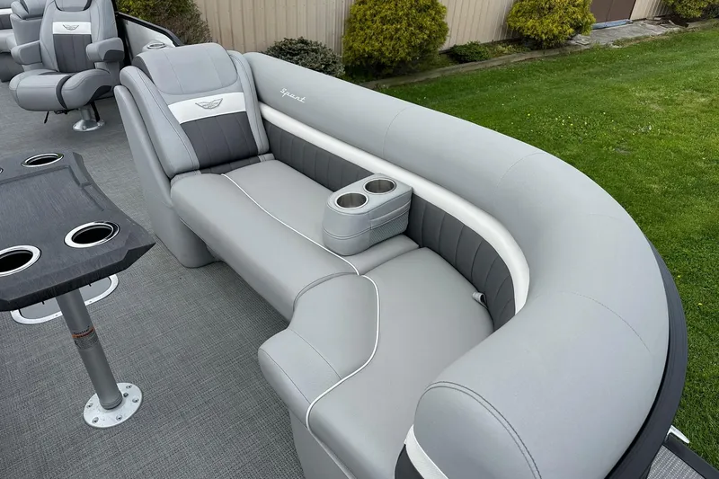 Slide: The Image of 2024 Bennington LX Sport Line boat interior with gray seating and cup holders. - 16