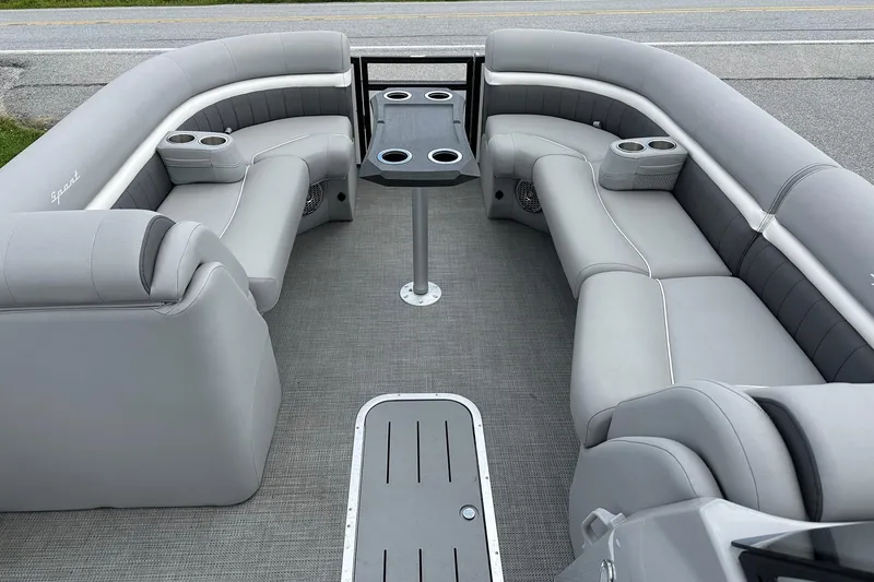 Slide: The Image of 2024 Bennington LX Sport Line pontoon boat interior with gray seating and cup holders. - 18