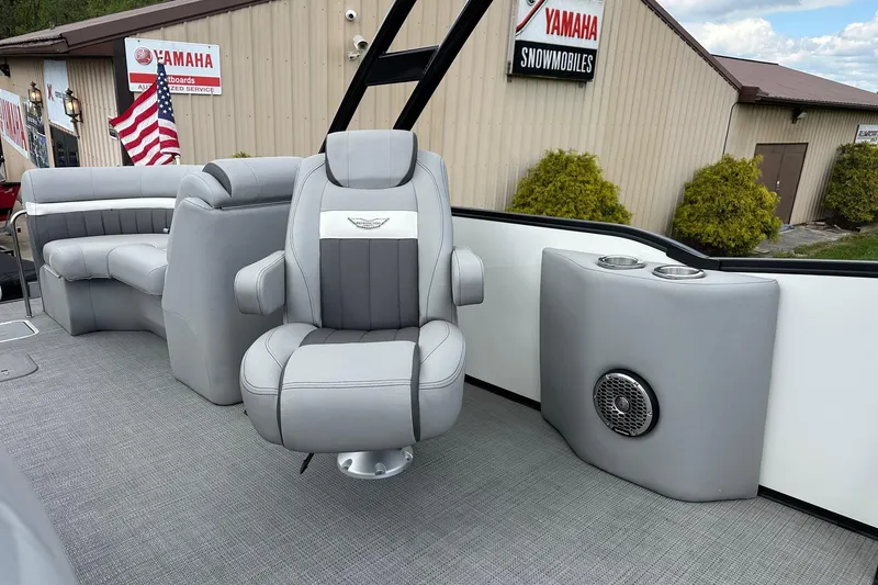 Slide: The Image of 2024 Bennington LX Sport Line boat interior with gray seating and cup holders. - 19