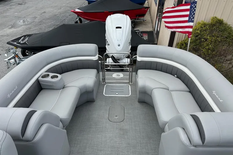 Slide: The Image of 2024 Bennington LX Sport Line pontoon boat with luxurious seating and American flag. - 20