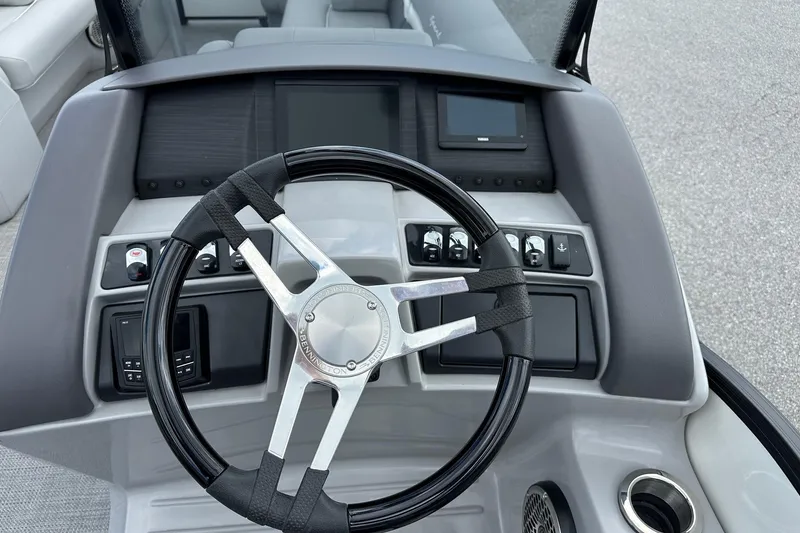 Slide: The Image of Steering console of 2024 Bennington LX Sport Line boat with modern controls and sleek design. - 23