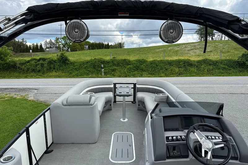 Slide: The Image of 2024 Bennington LX Sport Line boat interior with gray seating and modern dashboard. - 27