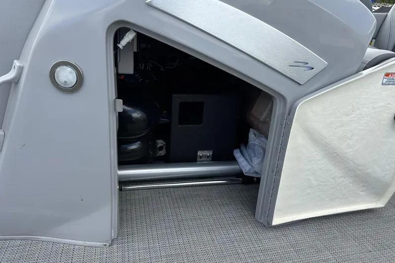 Slide: The Image of Open storage compartment on 2024 Bennington LX Sport Line boat. - 29
