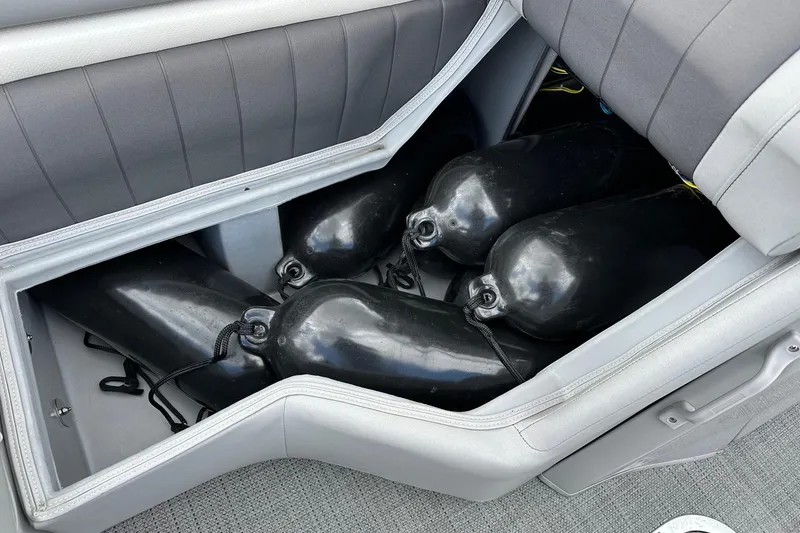 Slide: The Image of Storage compartment in 2024 Bennington LX Sport Line boat with black fenders. - 30
