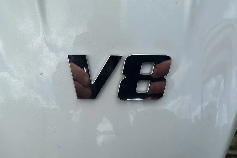 Slide: The Image of 2024 Bennington LX Sport Line V8 emblem on a sleek white surface. - 33