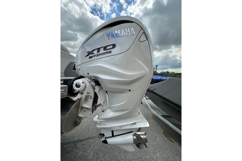 Slide: The Image of Yamaha XTO Offshore engine on 2024 Bennington LX Sport Line boat, under cloudy sky. - 9