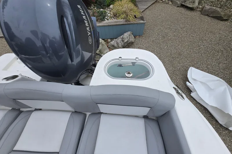 Slide: The Image of 2021 NauticStar 2302 Legacy boat with Yamaha engine and seating area. - 12