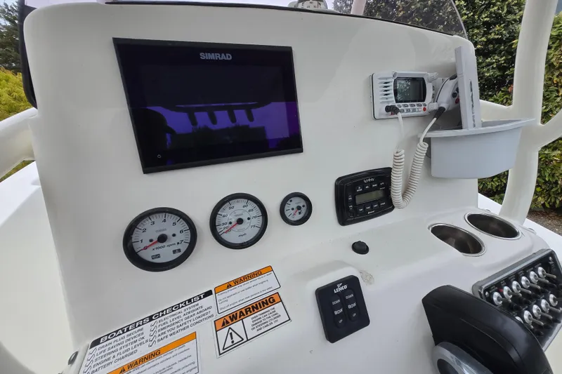 Slide: The Image of Dashboard of a 2021 NauticStar 2302 Legacy boat with gauges and controls. - 13