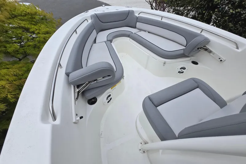 Slide: The Image of 2021 NauticStar 2302 Legacy boat interior with gray seating and stainless steel railings. - 14