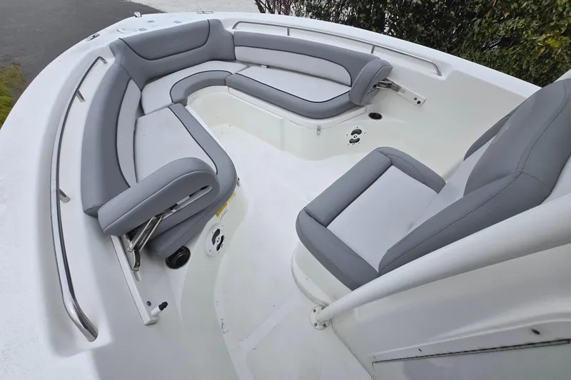 Slide: The Image of 2021 NauticStar 2302 Legacy boat interior with gray cushioned seating. - 17