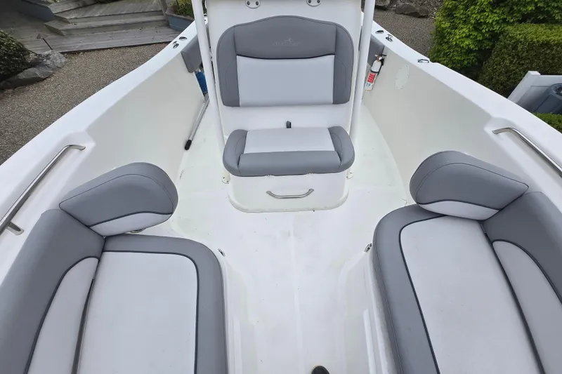 Slide: The Image of 2021 NauticStar 2302 Legacy boat interior with gray cushioned seating. - 20