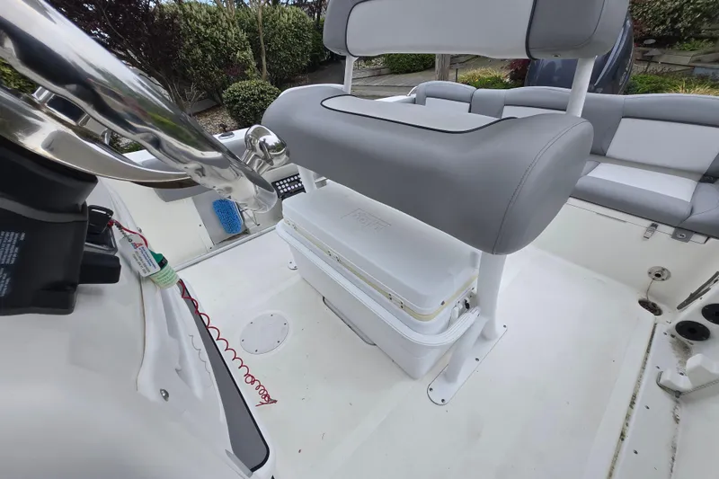 Slide: The Image of 2021 NauticStar 2302 Legacy boat interior with helm and seating area. - 21