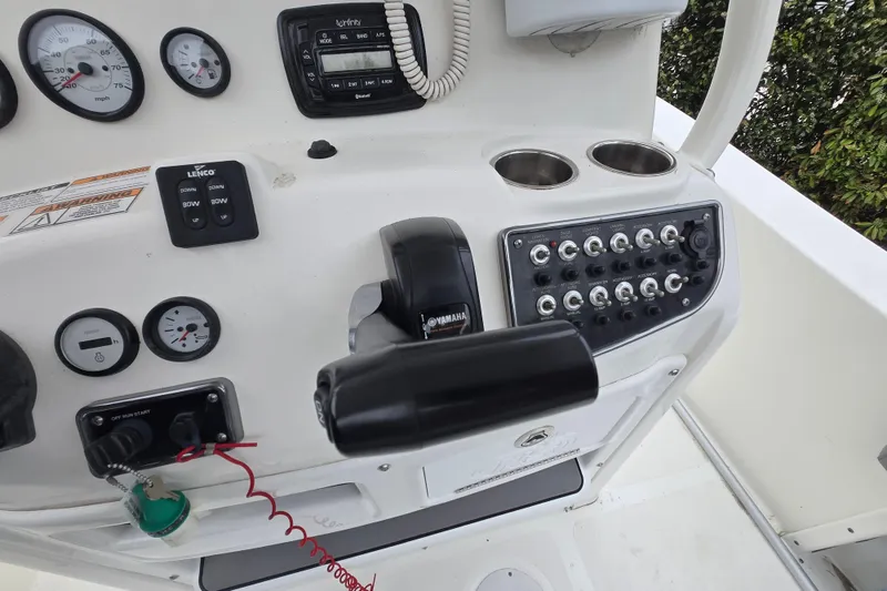 Slide: The Image of Control panel of a 2021 NauticStar 2302 Legacy boat with gauges and switches. - 23