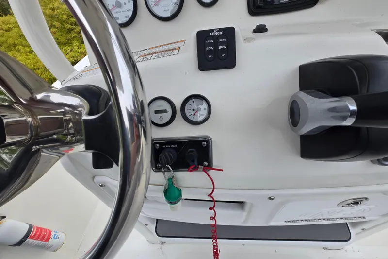 Slide: The Image of Steering console of 2021 NauticStar 2302 Legacy boat with gauges and controls. - 24