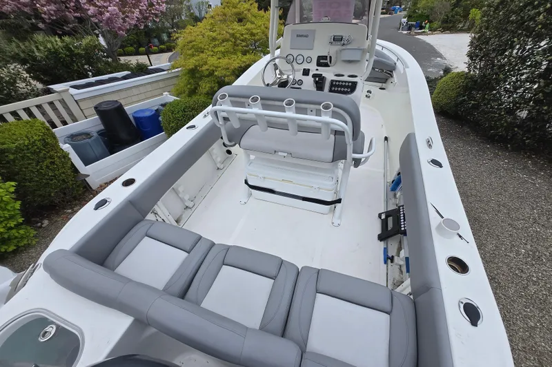 Slide: The Image of 2021 NauticStar 2302 Legacy boat interior with seating and control panel. - 26