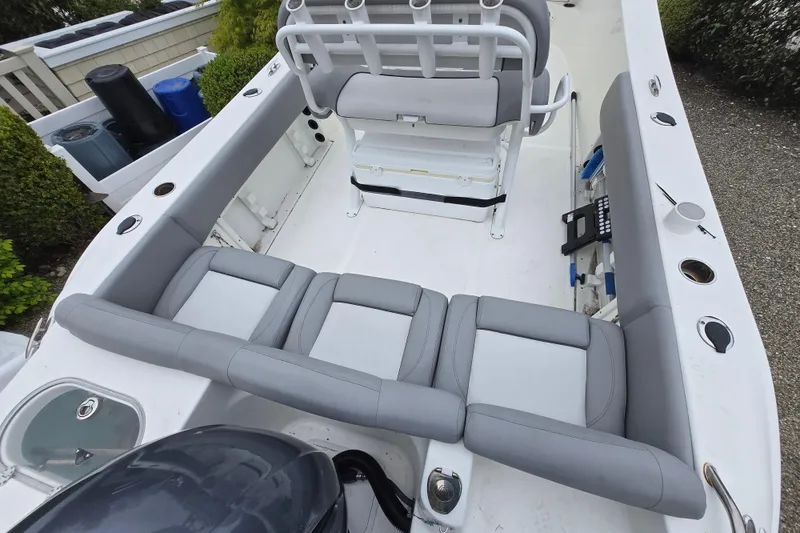 Slide: The Image of 2021 NauticStar 2302 Legacy boat interior with gray seating and fishing rod holders. - 27