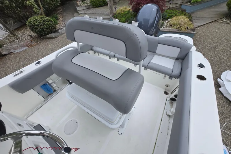 Slide: The Image of 2021 NauticStar 2302 Legacy boat interior with gray seating and steering wheel. - 3