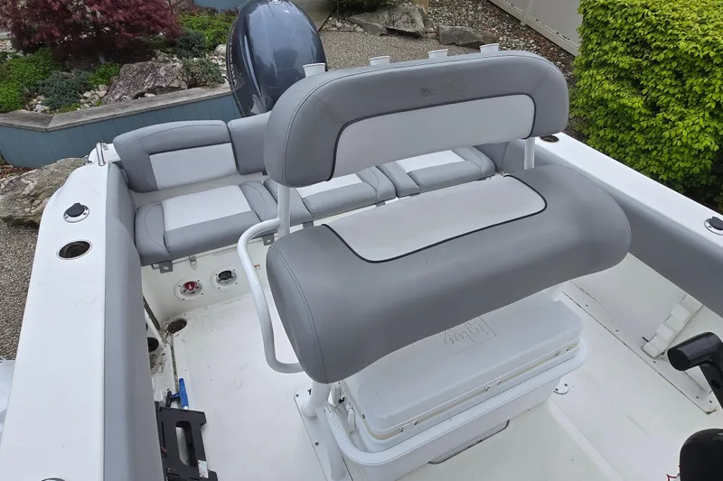 Slide: The Image of 2021 NauticStar 2302 Legacy boat interior with gray seating and storage. - 5